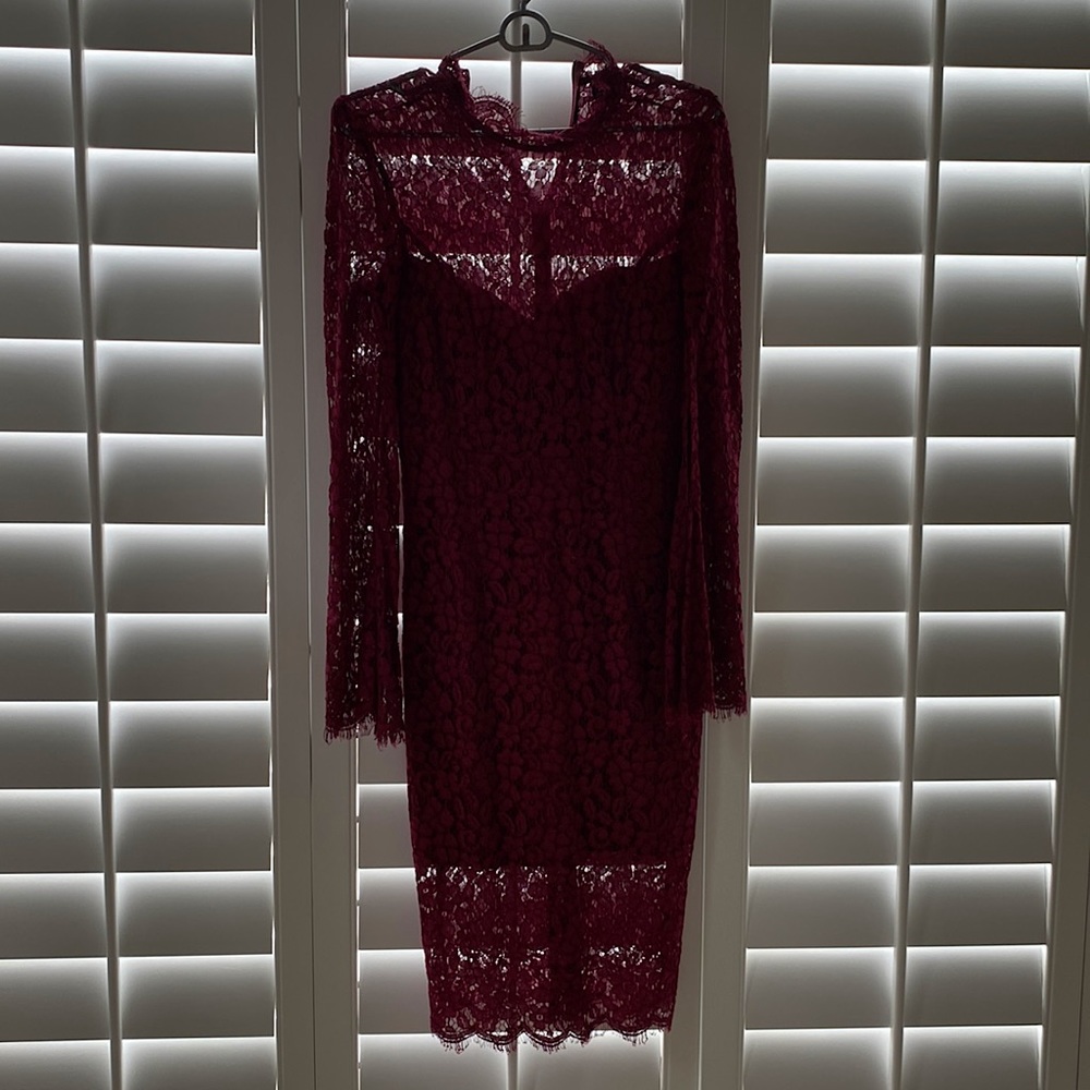 Wine color lace high neck midi dress. Sleeves are a bell sleeve with a slit
